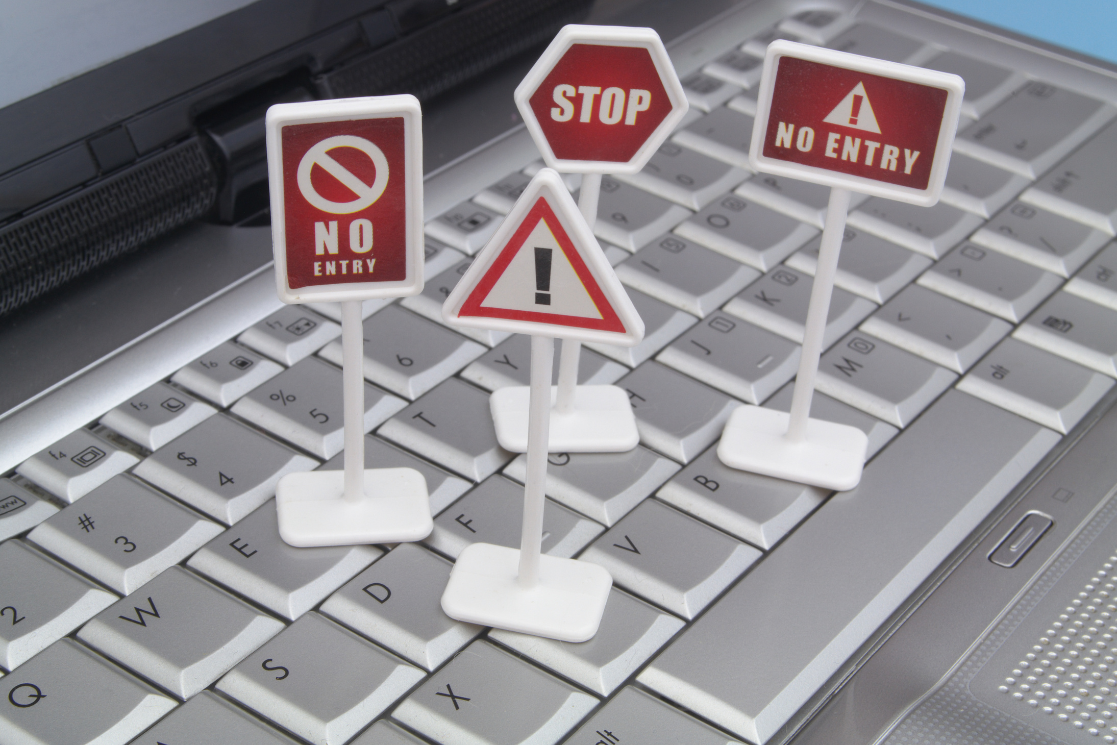 Warning and prohibition signs on computer keyboard.